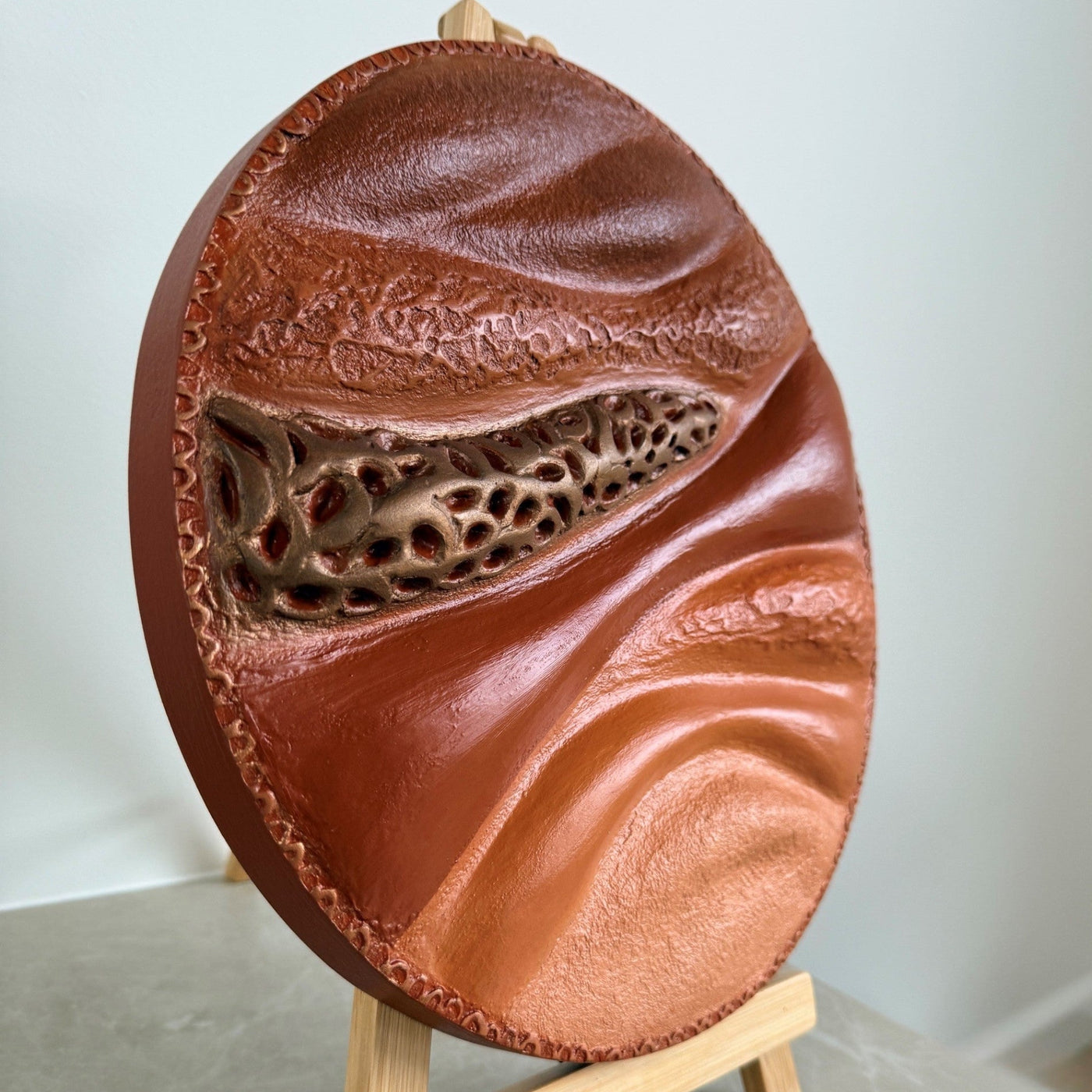Round textured sculpture painting - side view in natural light